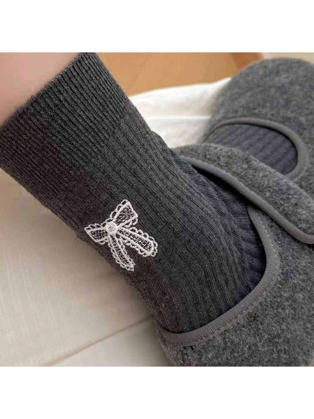 Dark Gray ribbed bow-motif sock styled with gray slippers