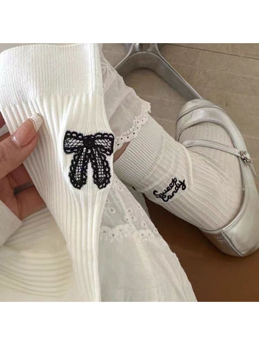 White ribbed bow-motif socks styled with white shoes