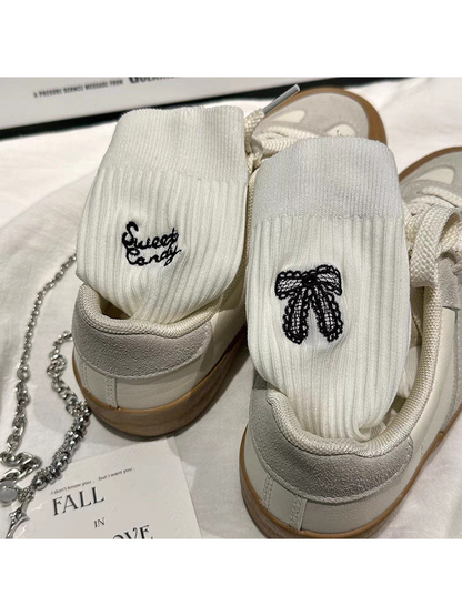 White ribbed socks with black bow and script embroidery