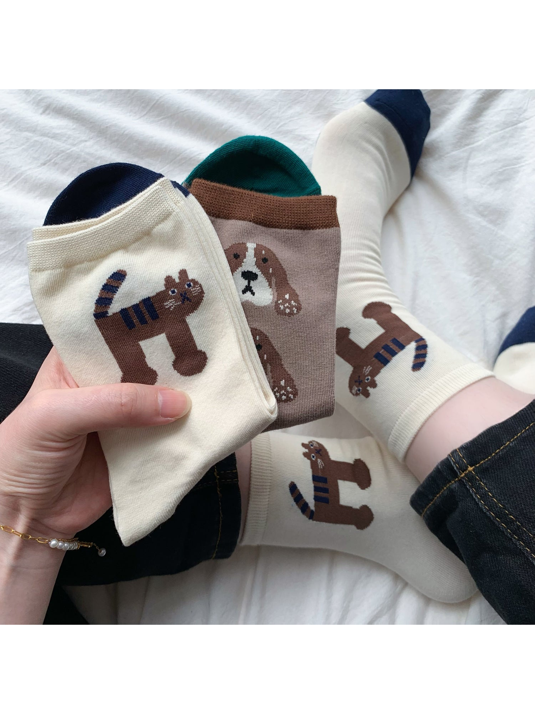 Tiger and Dog crew socks styled on feet and held together