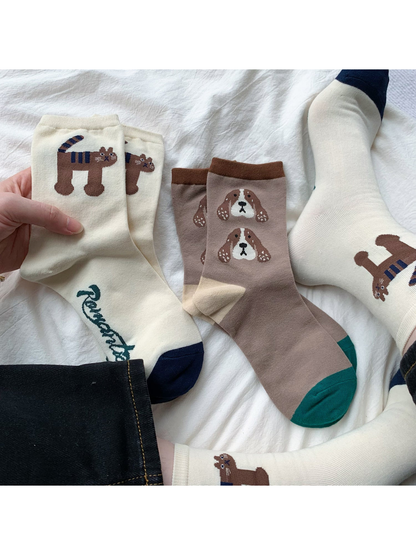 Tiger and Dog crew socks arranged flat and worn with dark jeans