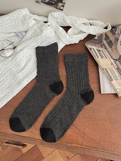 Dark gray openwork crew socks with black toes and heels, pair laid flat
