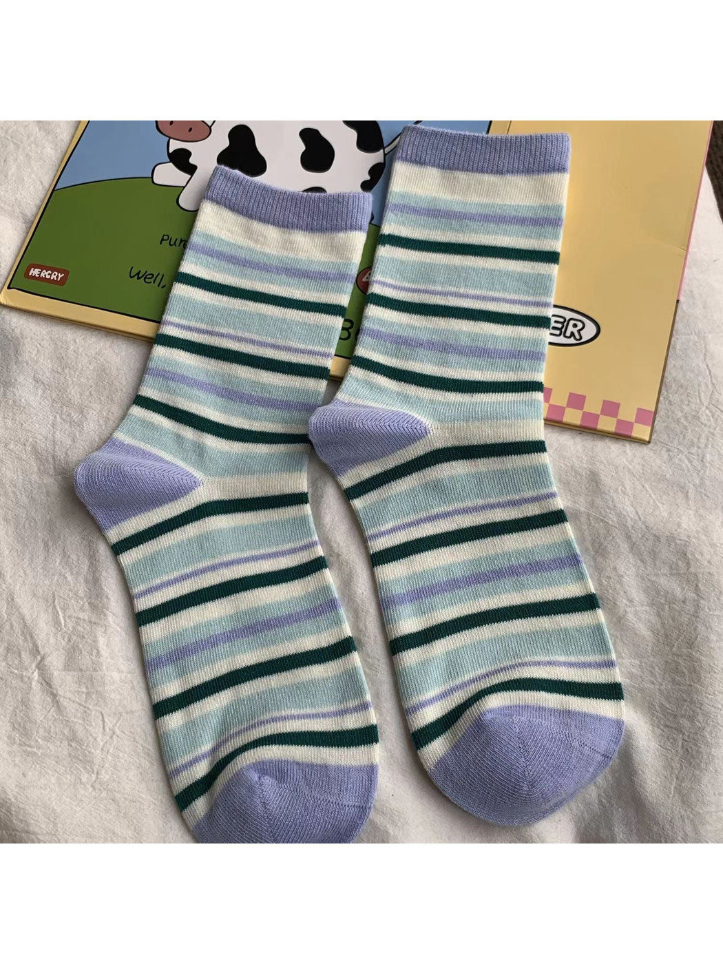 Blue striped crew socks with purple cuffs, heels and toes