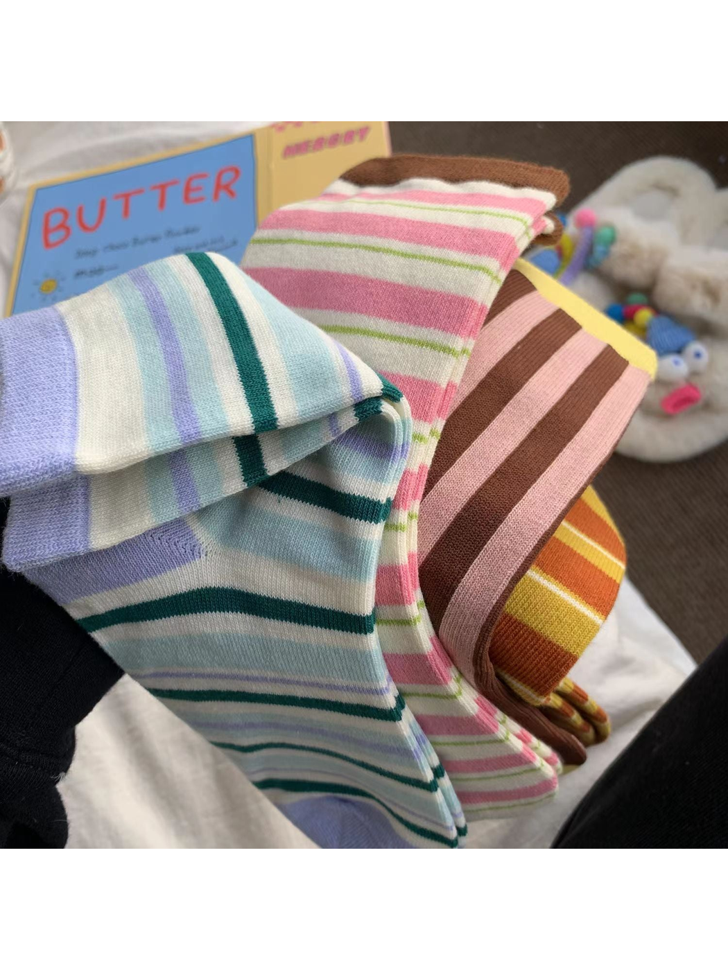 Close-up of the striped patterns, ribbed cuffs and knit texture