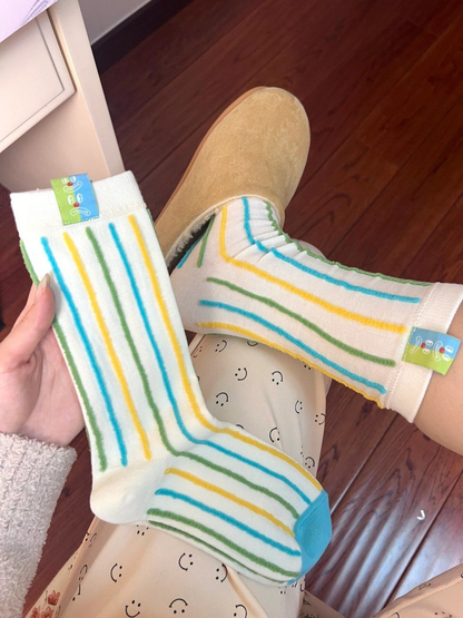 Vertical Stripe ivory socks with blue, green, and yellow lines