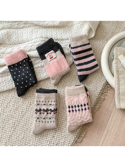 Five pink, charcoal and beige crew sock styles arranged together