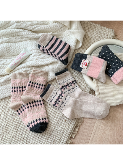 Five crew sock styles arranged flat to show their patterns and full length