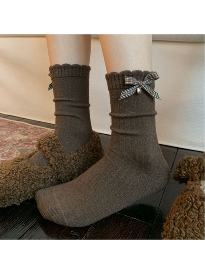 Dark brown Plaid crew socks styled with fuzzy brown slippers