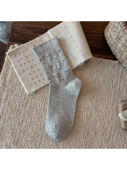 Light Gray crew sock with miniature pink flower motifs, flat display