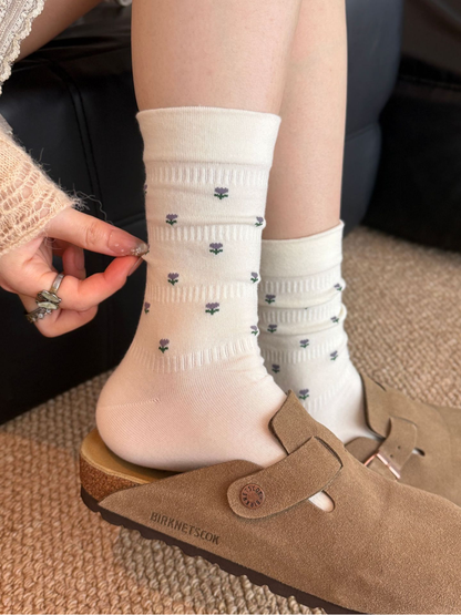 Ivory floral crew socks worn with brown clogs, side view