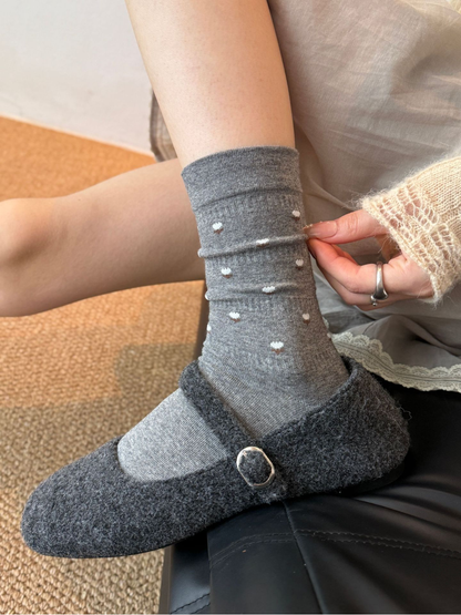 Dark Gray crew socks with miniature white flower motifs worn with gray slippers