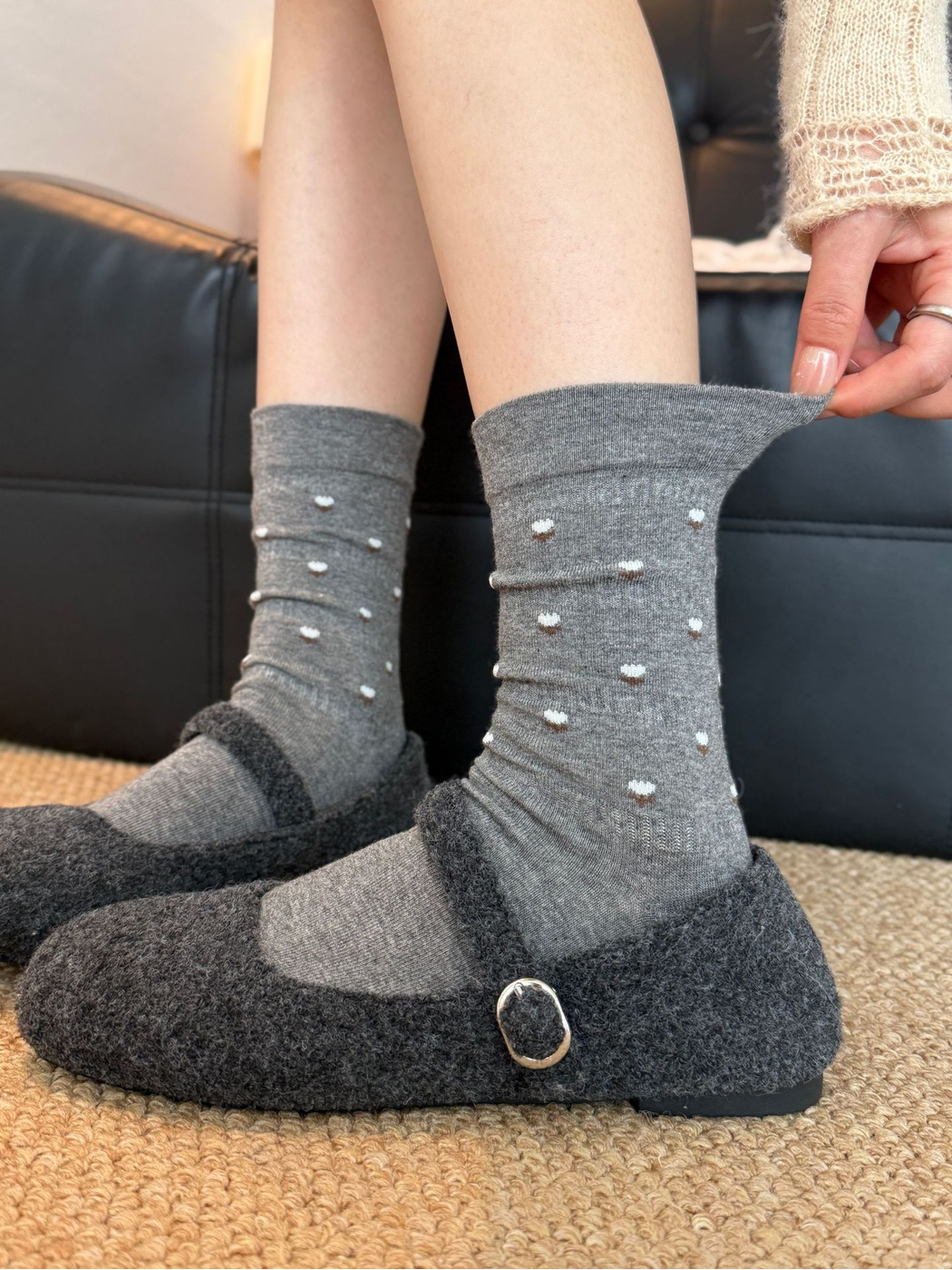 Dark Gray floral crew socks worn with gray slippers, front view with cuff extended