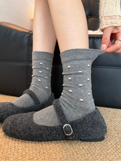 Dark Gray floral crew socks worn with gray slippers, front view with cuff extended