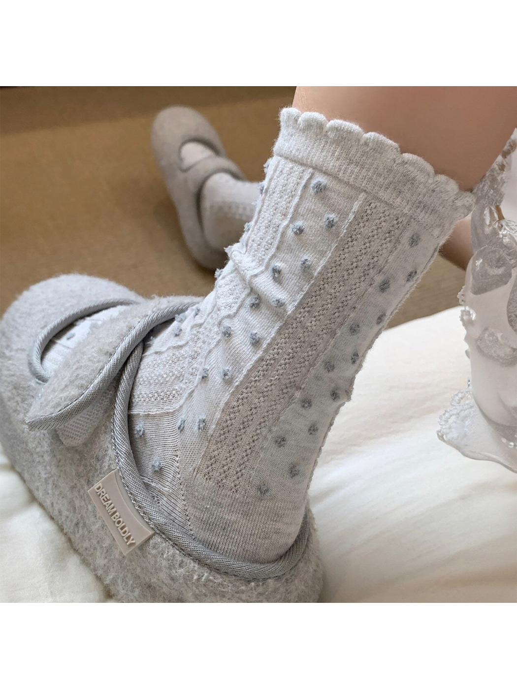 Gray Blue pointelle crew socks with raised dots and a scalloped cuff