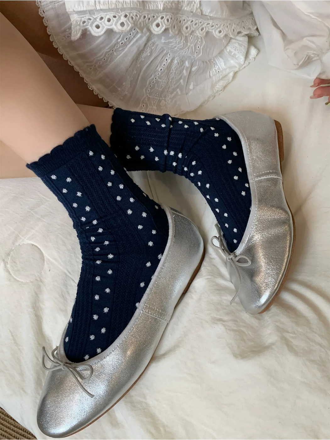 Navy raised-dot crew socks styled with silver-tone flats