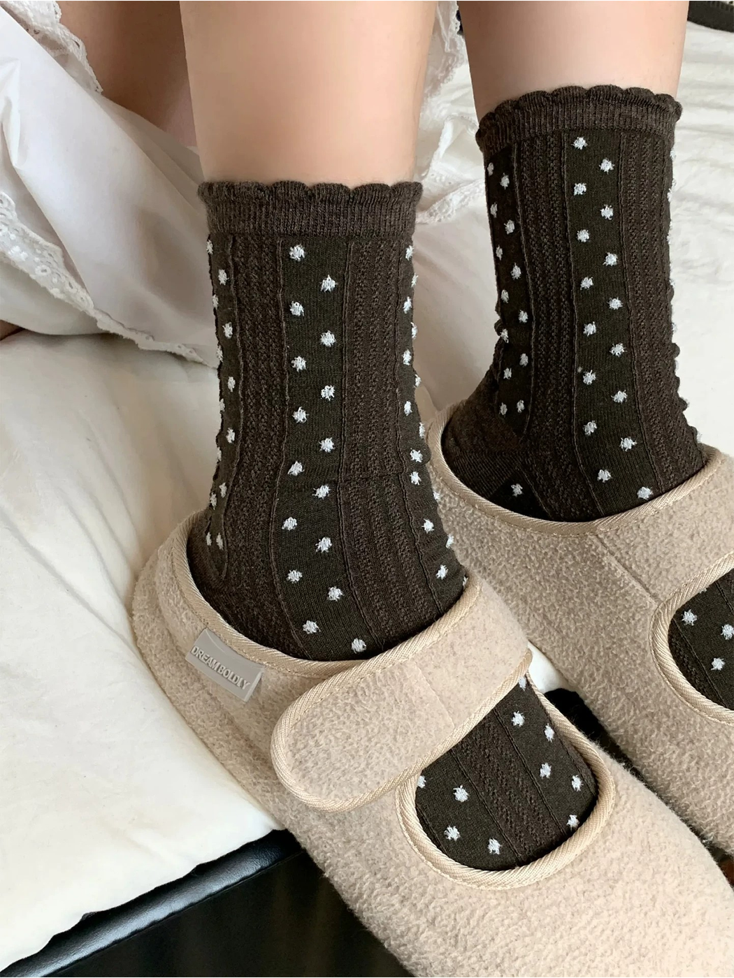 Coffee raised-dot crew socks styled with beige slippers
