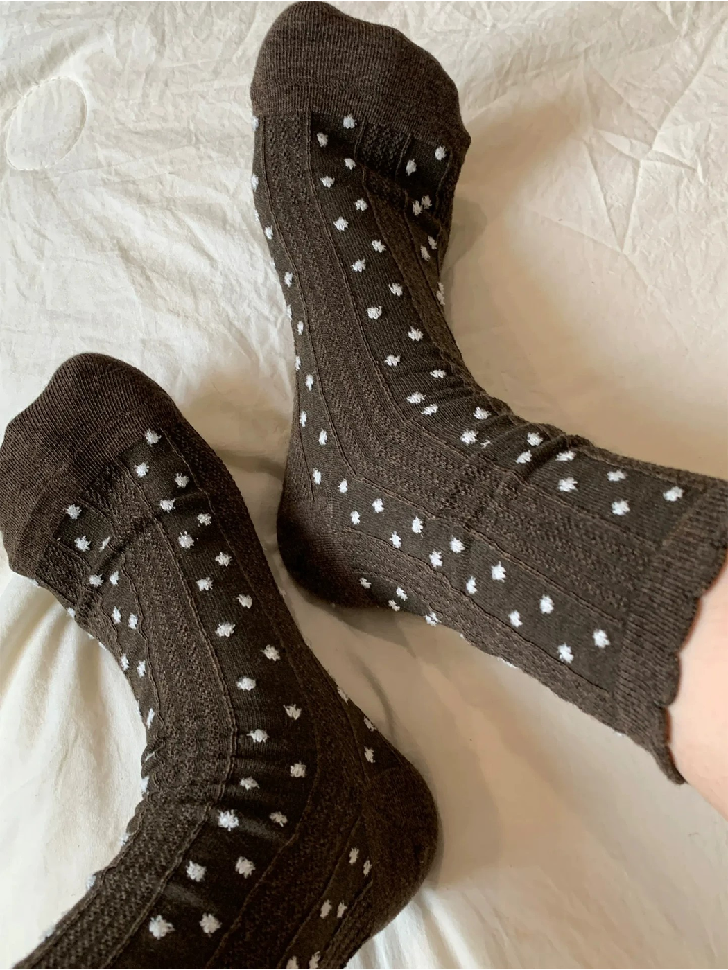 Coffee raised-dot crew socks displayed without shoes to show the full pattern