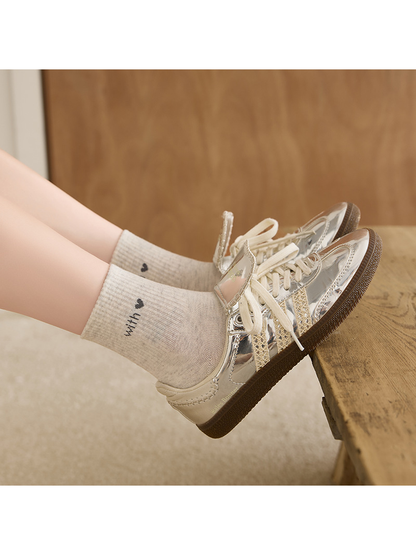 Light Gray crew socks worn with metallic-look sneakers