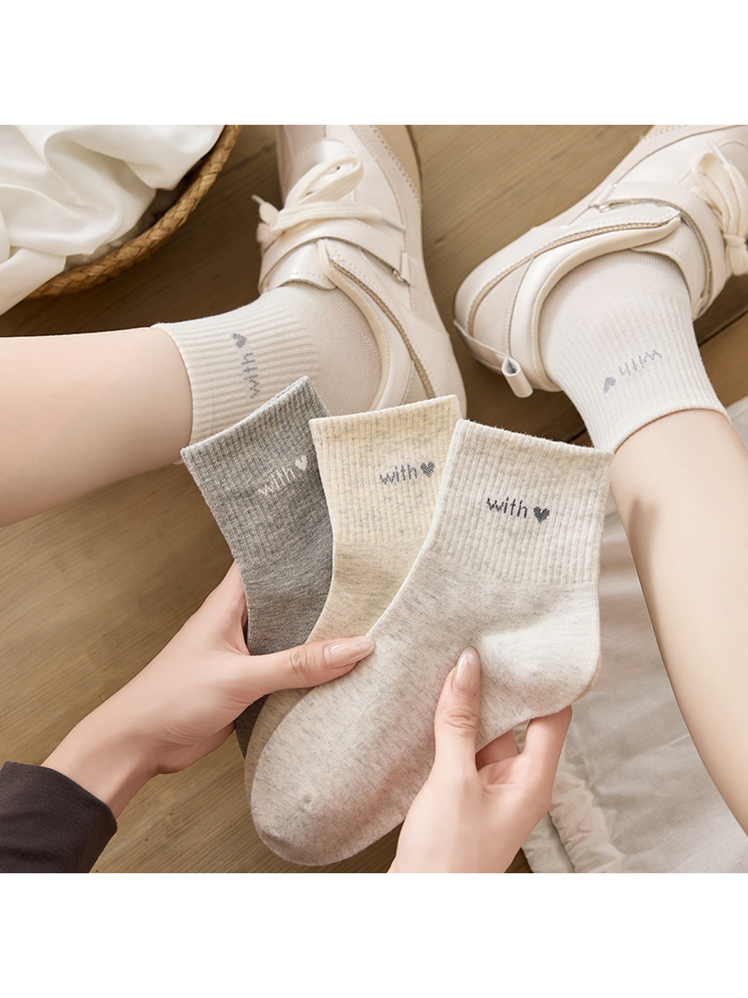 Gray, khaki and ivory crew socks displayed together with two worn pairs