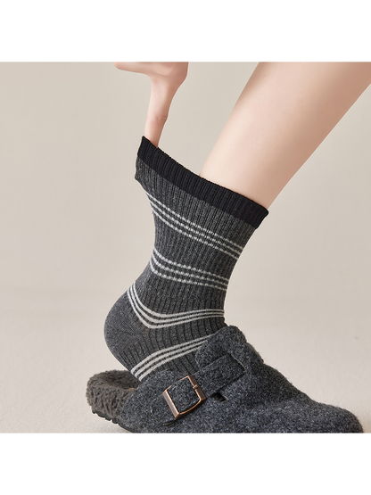 Close-up of a Black Gray striped crew sock and ribbed cuff