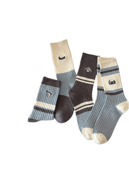 Multiple striped and embroidered ribbed crew sock styles arranged together
