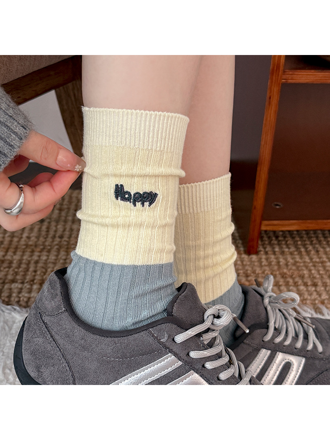 Close-up of a Happy style ribbed crew sock worn with a gray sneaker