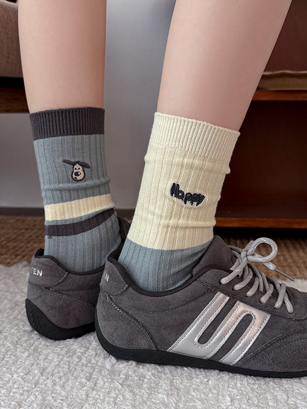 Happy and Cap style ribbed crew socks worn with gray sneakers