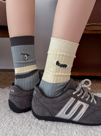 Happy and Cap style ribbed crew socks worn with gray sneakers