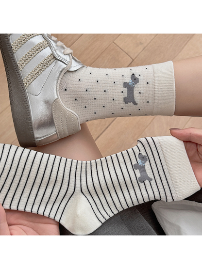 Close-up of Ivory Dots and Ivory Stripes socks with dog motifs