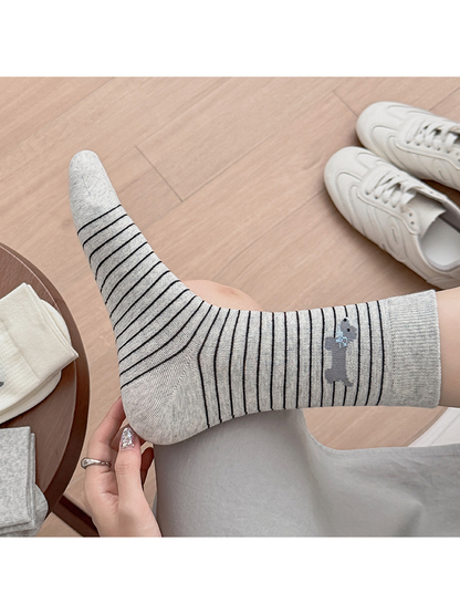 Close-up of a Gray Stripes crew sock with a dog motif