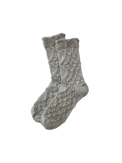 Gray mid-calf socks with a ruffled cuff and openwork diamond pattern