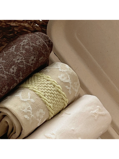 Close-up of botanical, geometric and raised floral sock textures
