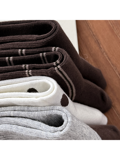 Close-up of folded sock openings and striped, polka dot, and ribbed textures