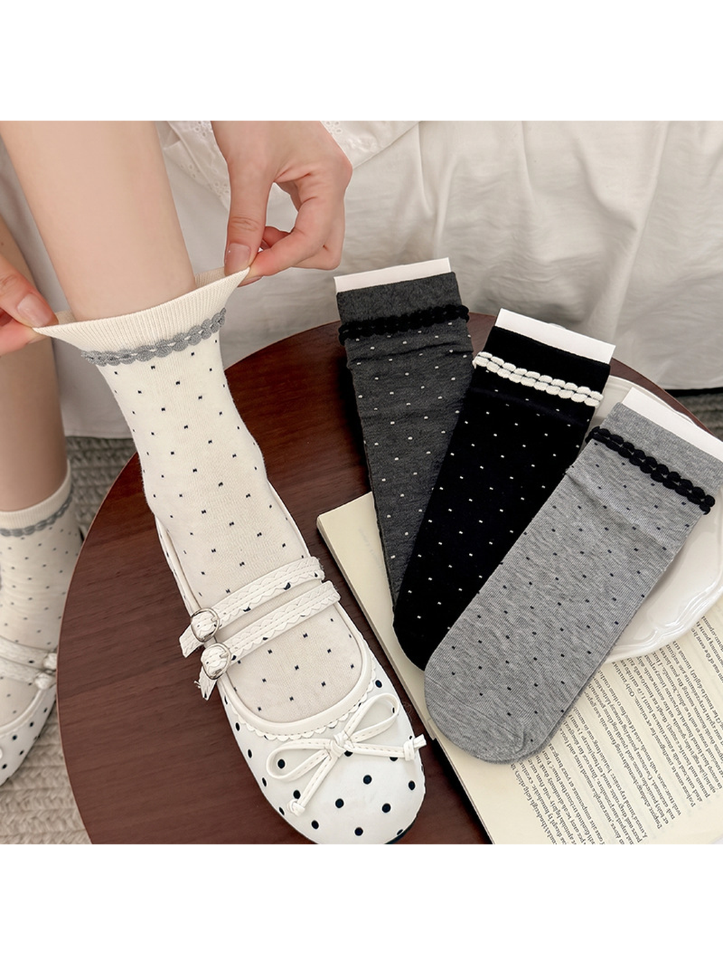 White, black and gray polka-dot crew socks displayed with a styled outfit