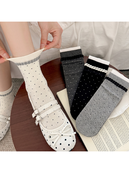 White, black and gray polka-dot crew socks displayed with a styled outfit