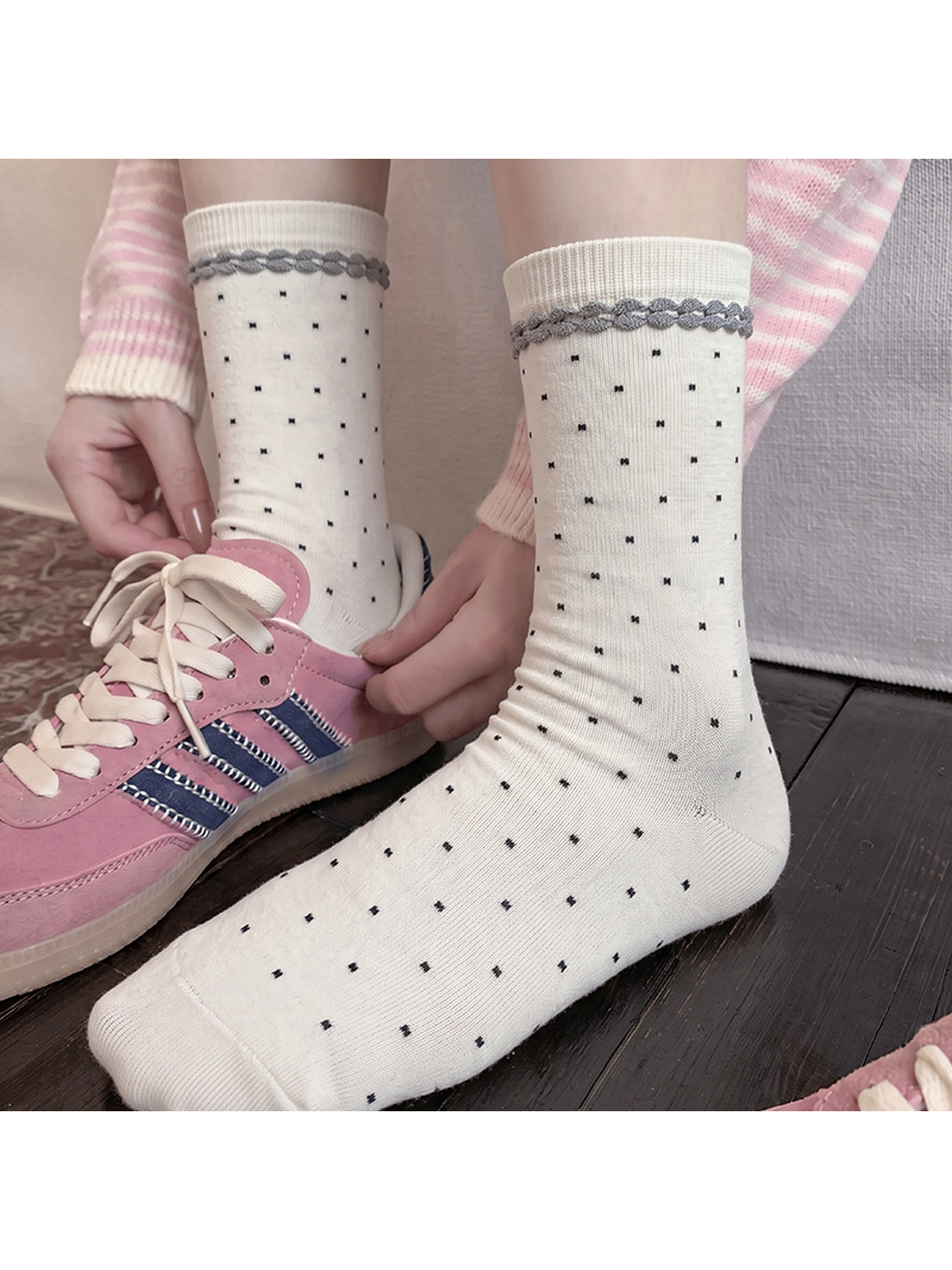 White polka-dot crew socks styled with pink sneakers