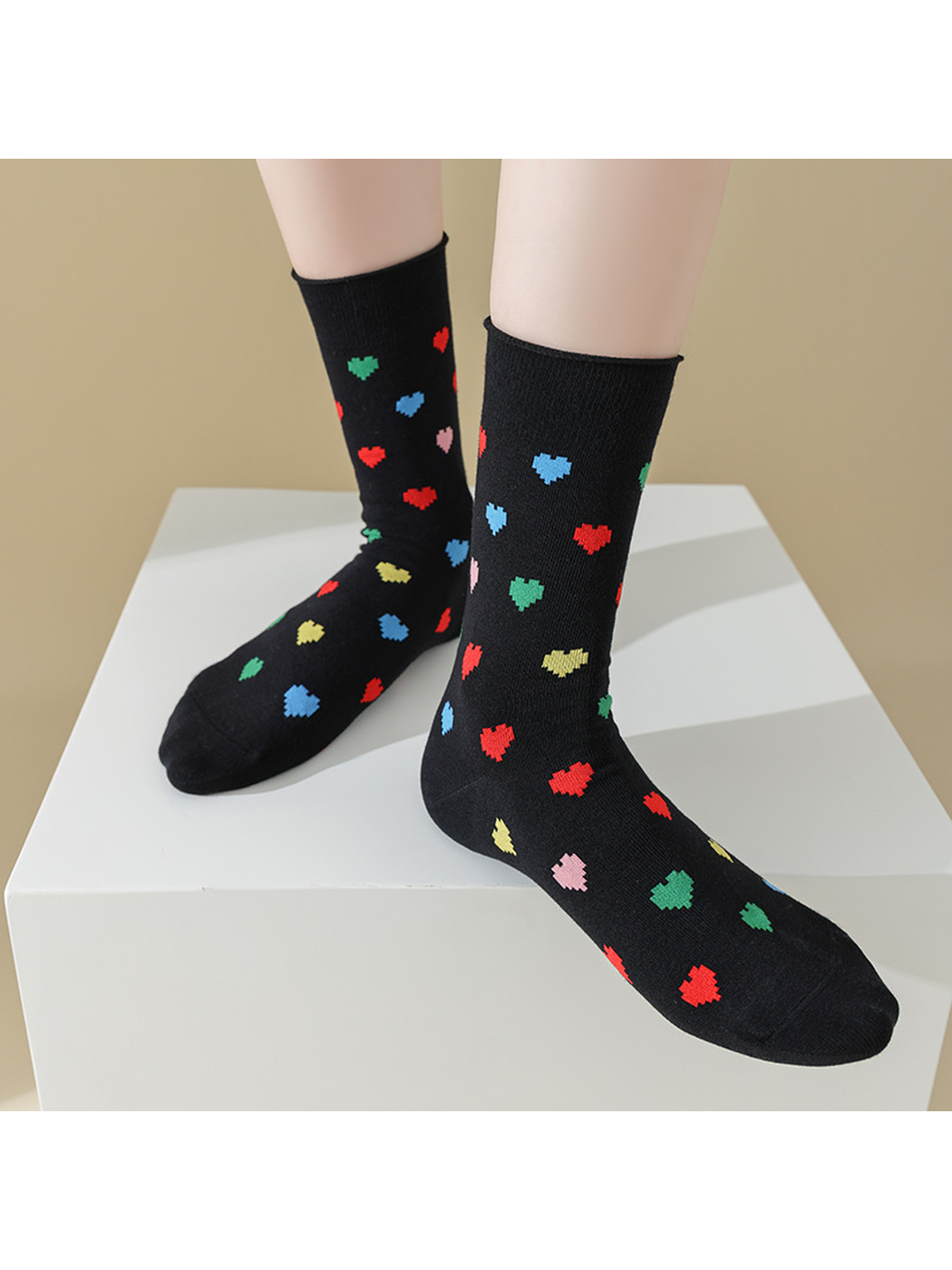 Black Hearts socks worn on a display platform