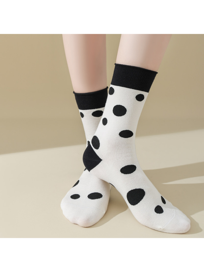 Black Dots socks worn with crossed ankles