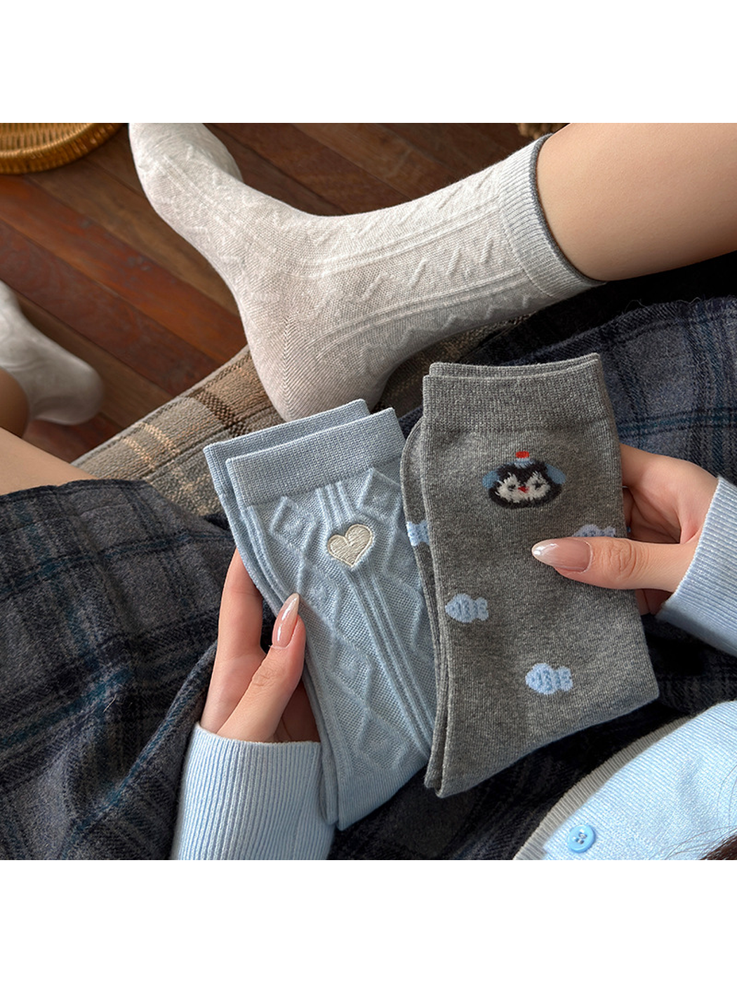 Waves socks worn with folded Heart and Fish styles held in hand