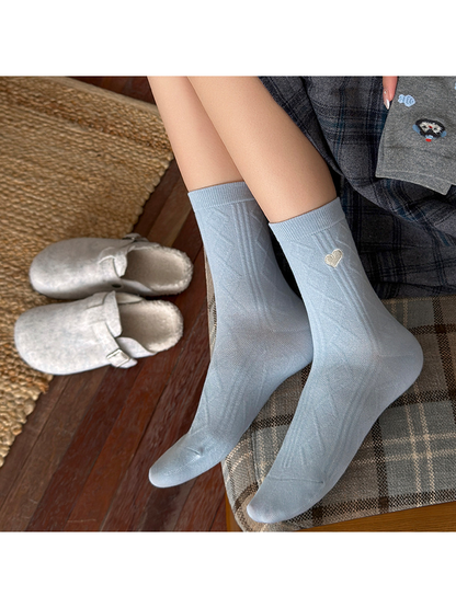 Light blue Heart crew socks worn with geometric knit panels visible