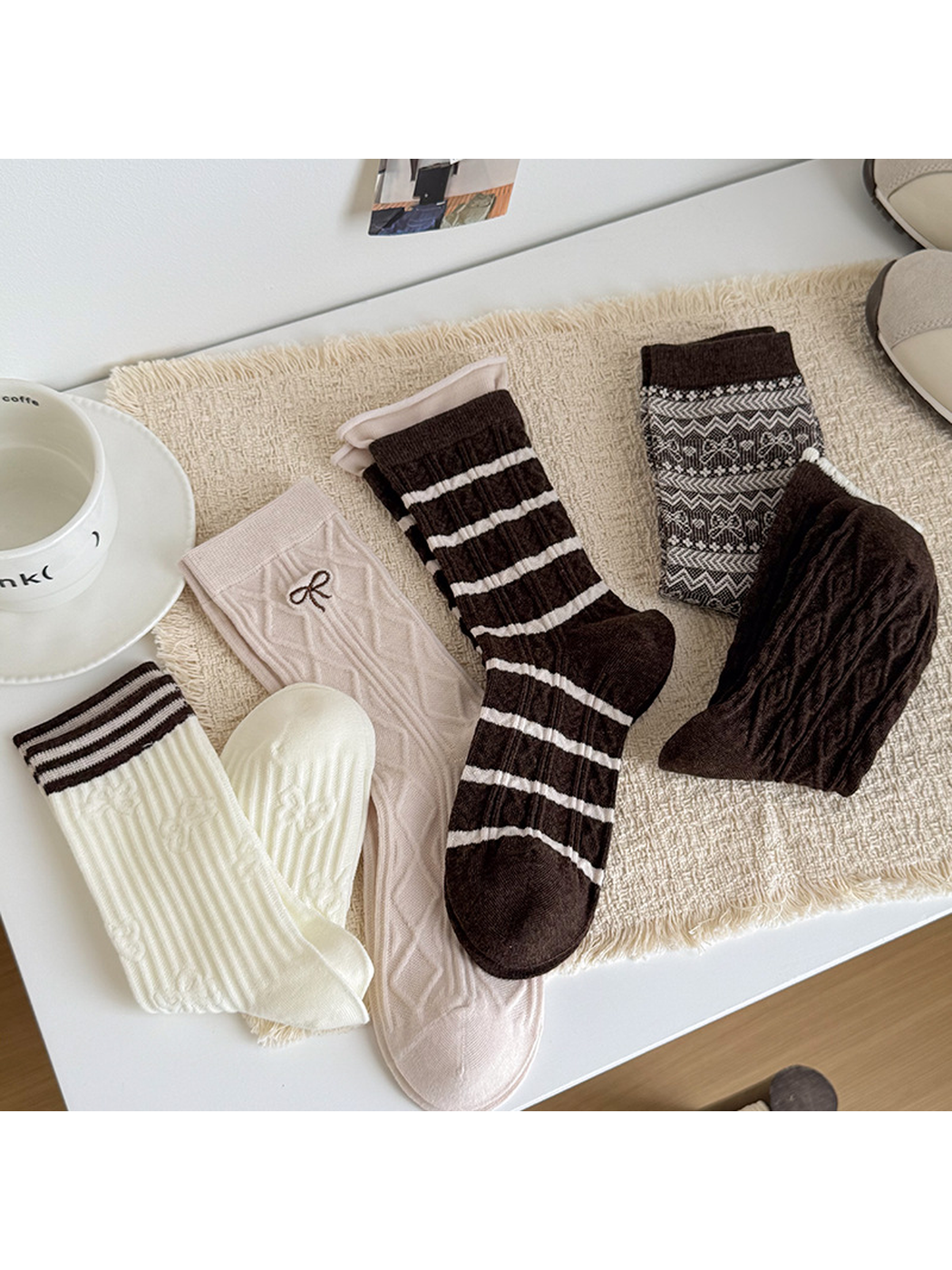 Ivory Stripe, Pink Bow, Brown Stripe, Brown Bow, and Brown Cable crew socks arranged together
