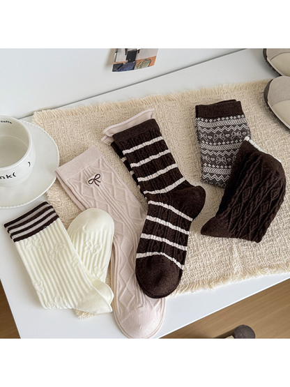 Ivory Stripe, Pink Bow, Brown Stripe, Brown Bow, and Brown Cable crew socks arranged together