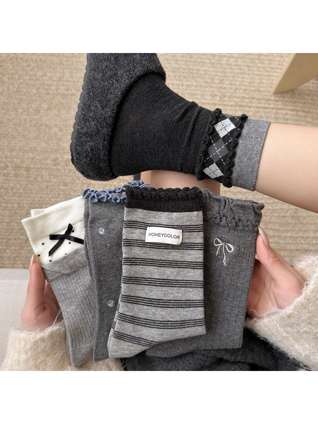 Five gray and black crew sock styles displayed together