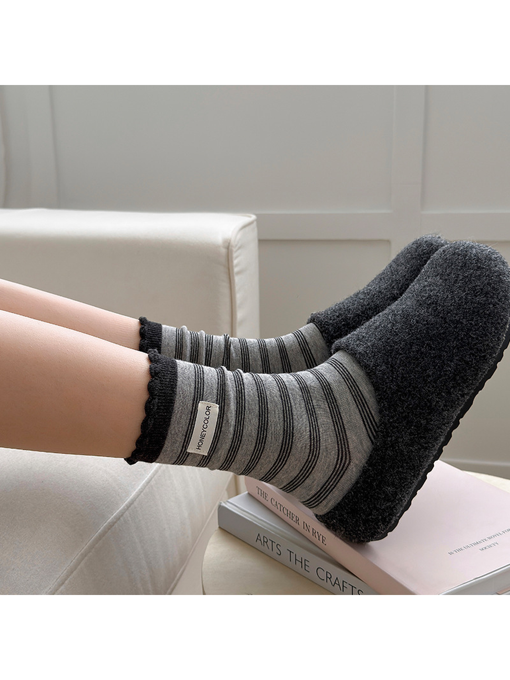 Label gray striped crew socks styled with dark slippers