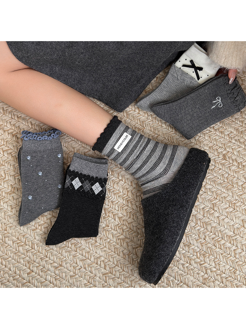 Multiple sock styles arranged around a worn striped crew sock