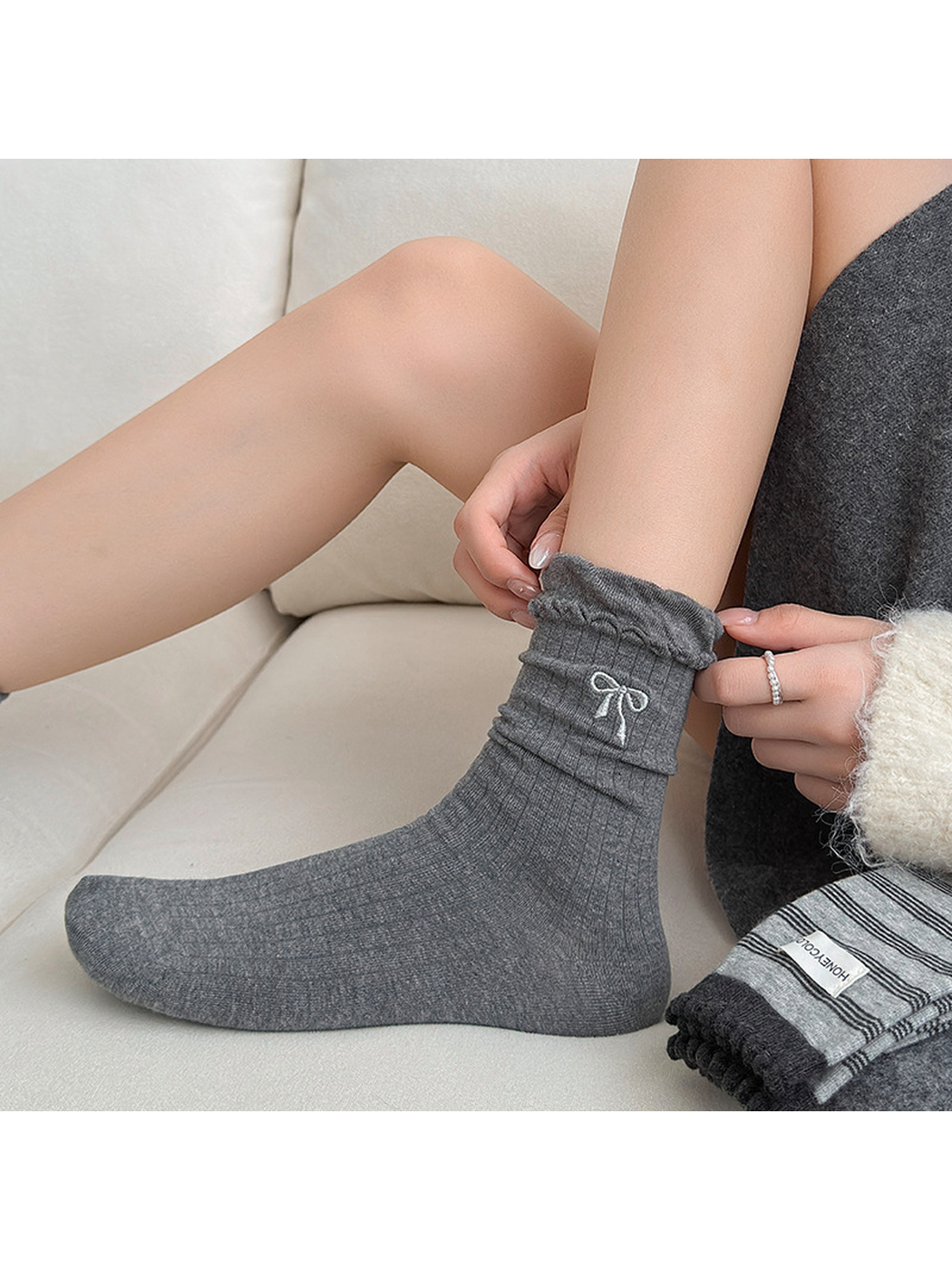 Bow gray ribbed crew sock worn with the ruffled cuff gathered