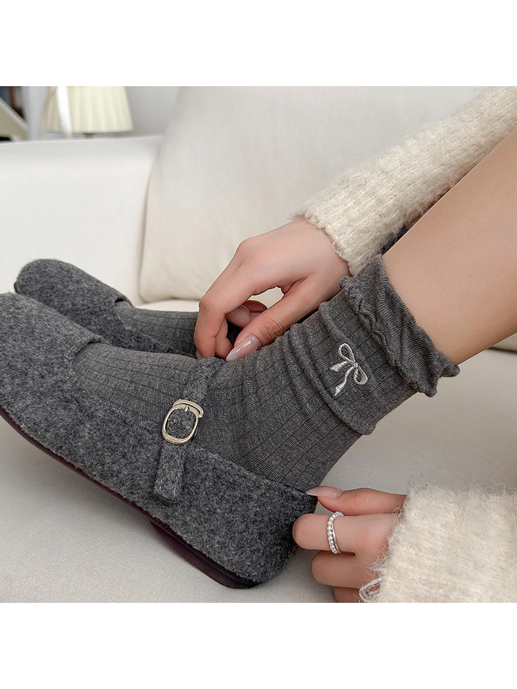 Close-up of the Bow sock's ribbing, embroidered bow, and ruffled cuff