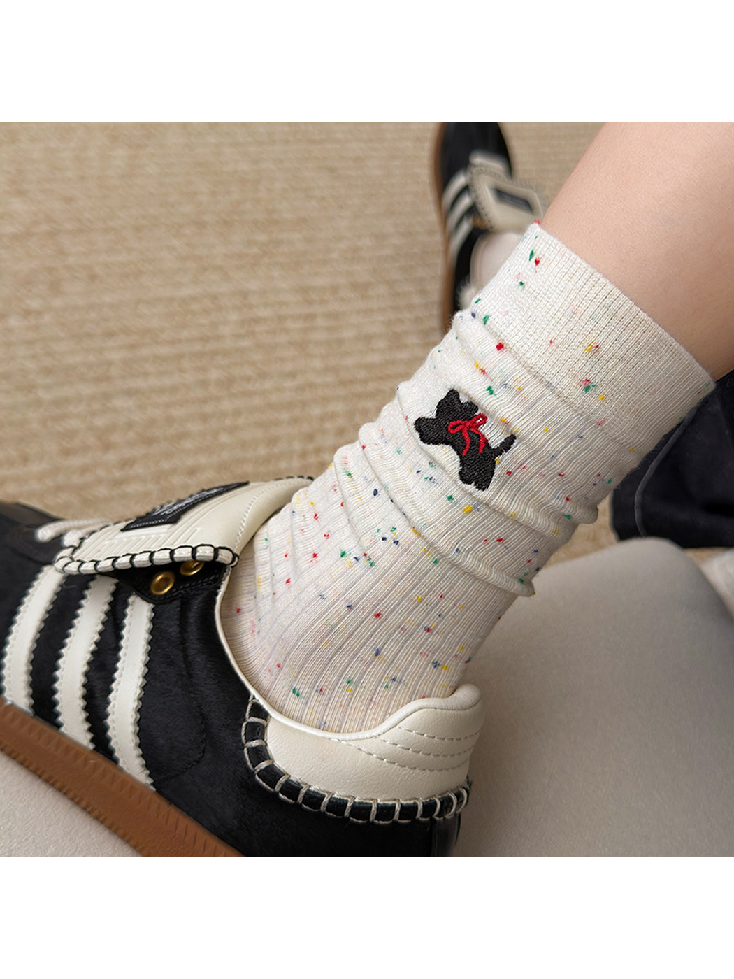 Close-up of Speckled Cat sock embroidery and multicolor flecks