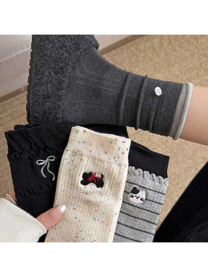 Multiple sock styles showing bow, cat, stripe and button details