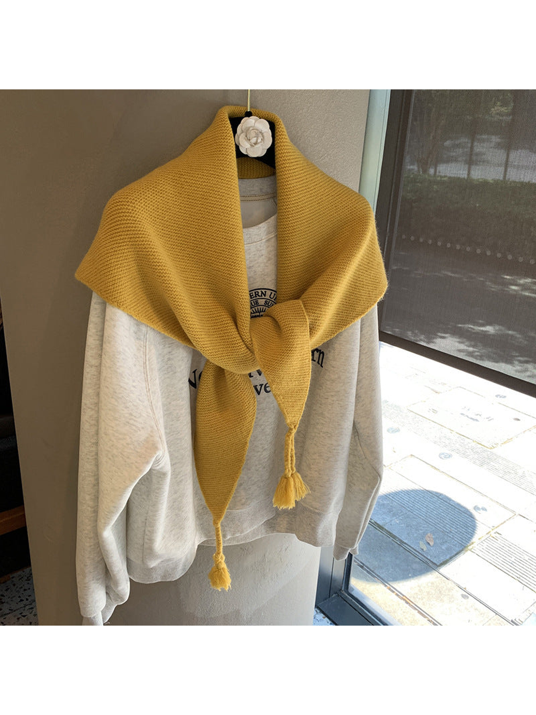 Mustard Yellow triangle scarf tied over a sweatshirt